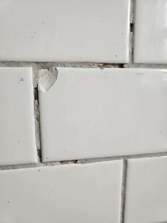 Chipped tile and patchy grout
